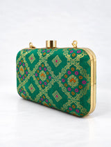 Light green Mahi box clutch by THE TAN CLAN with gold clasp and sleek rectangular design, ideal for elegant evening occasions.