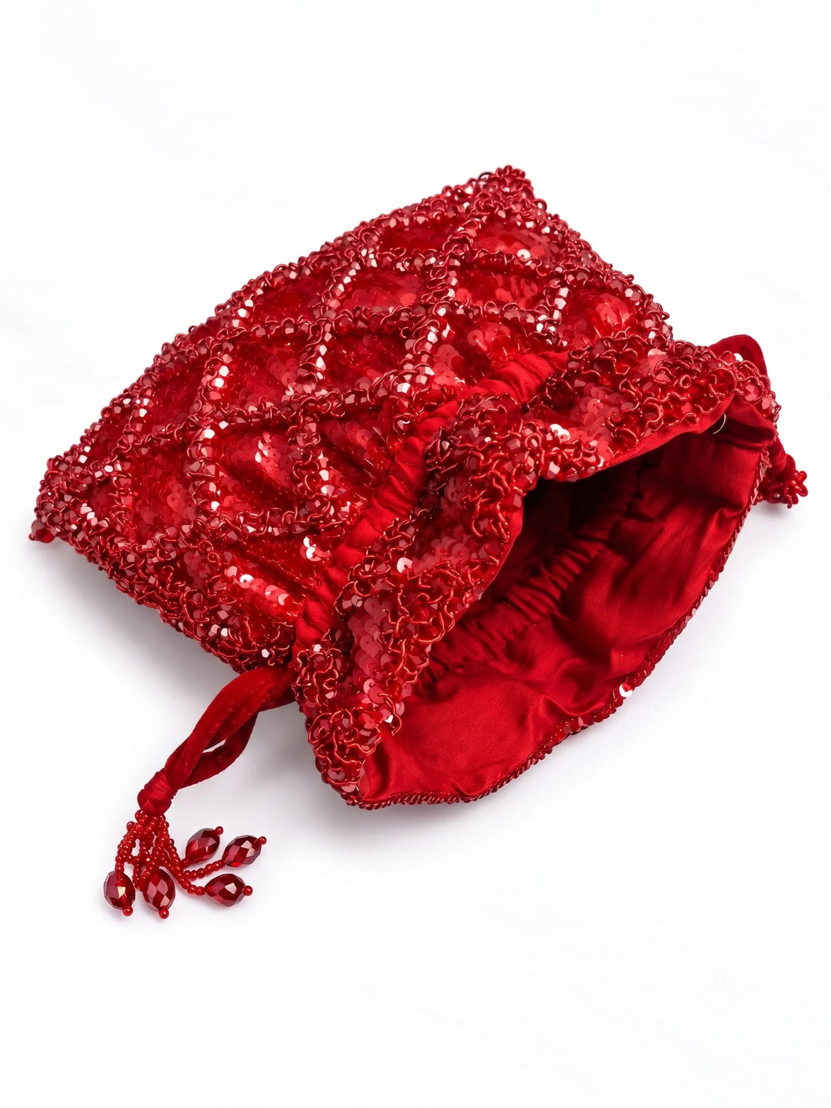 Red sequined tasselled potli bag by THE TAN CLAN with intricate embroidery and a drawstring closure.
