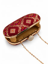 Red oval clutch bag by THE TAN CLAN with a sleek design and smooth leather finish.