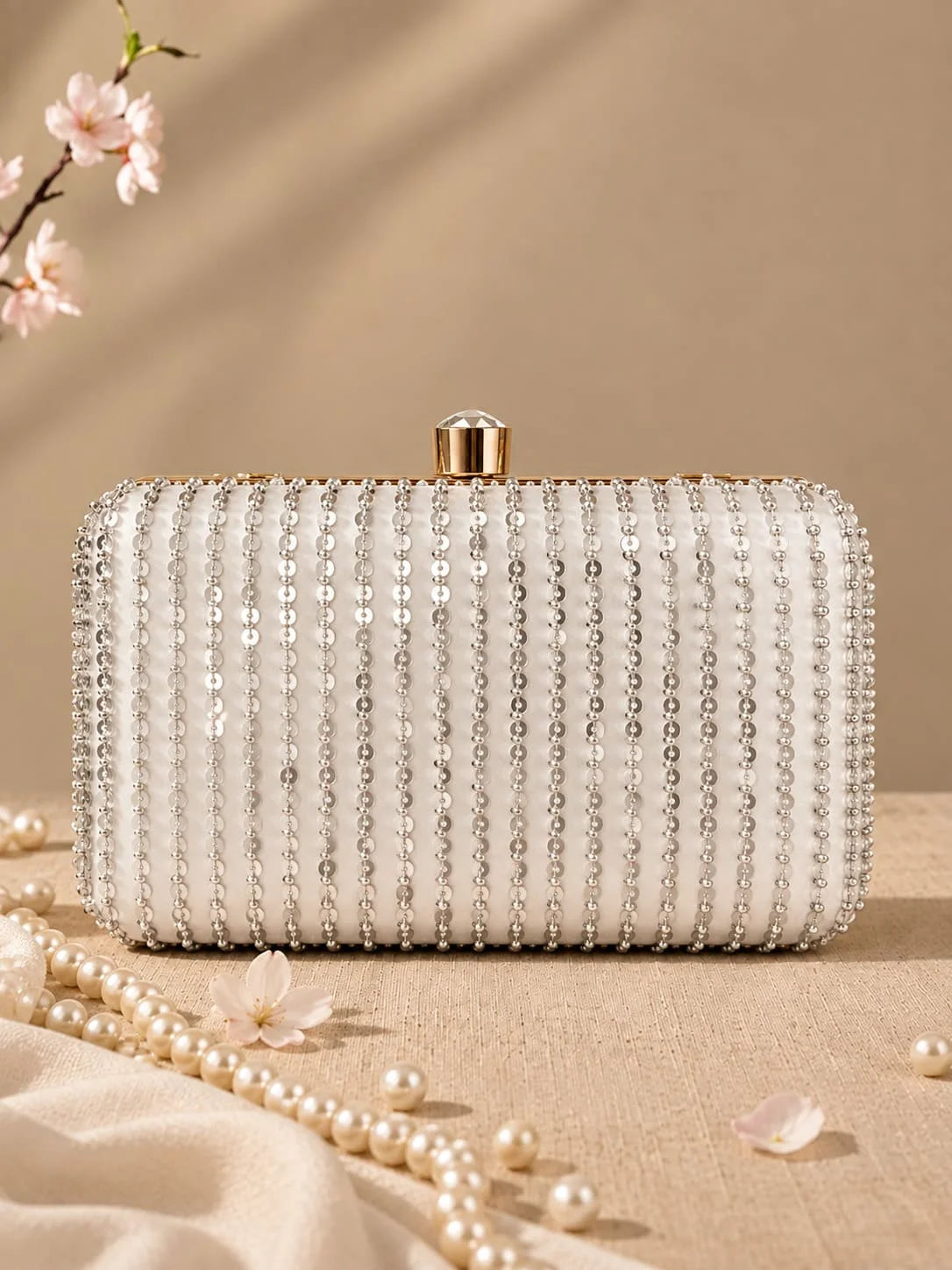 Silver embroidered Glitty box clutch by THE TAN CLAN featuring intricate embroidery and a sleek rectangular shape.