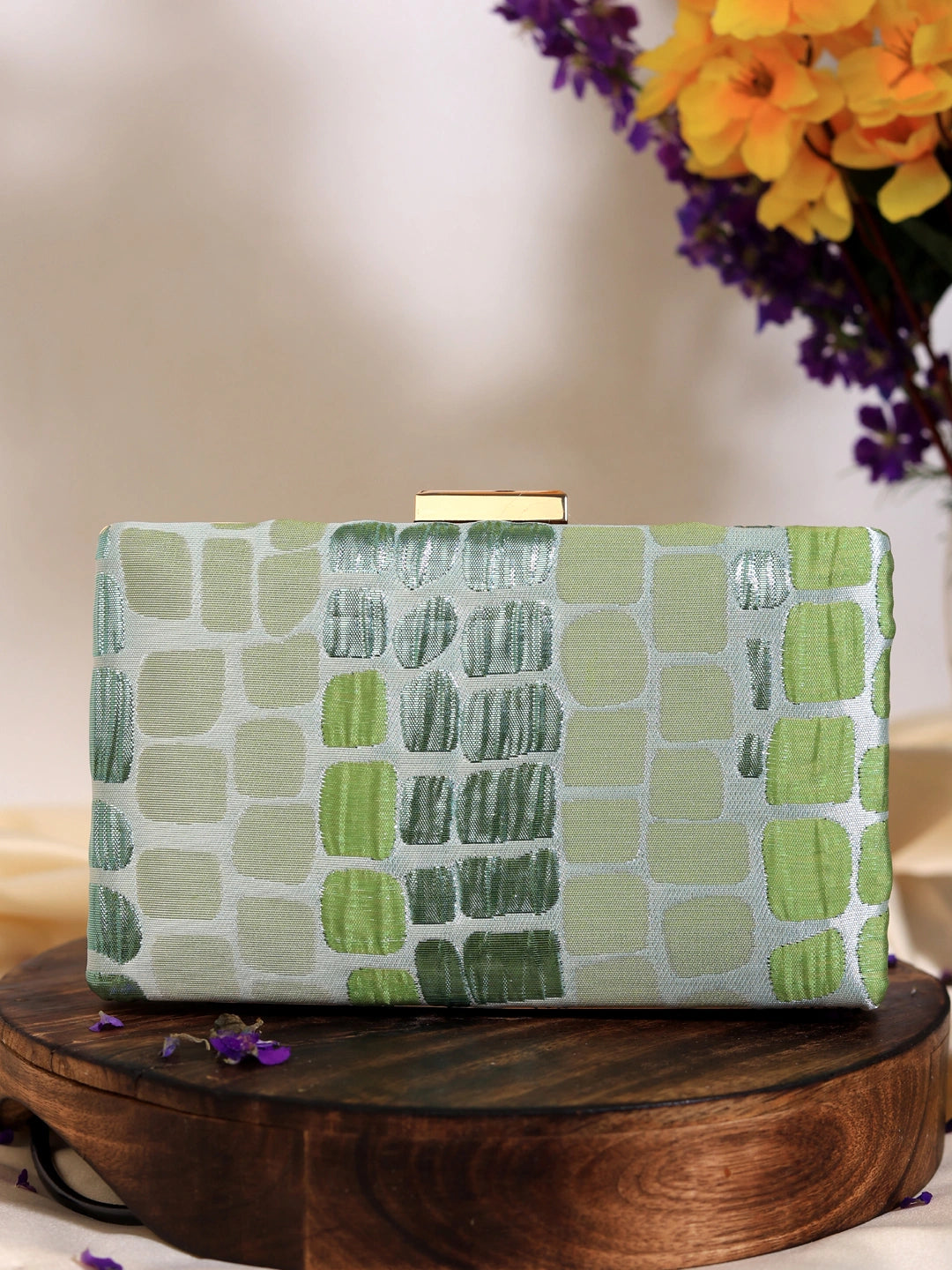 Coral Sleek Green Clutch by The Tan Clan featuring a smooth, vibrant coral-green exterior with a stylish compact design.