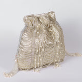 Sharda Potli bag with handle from The Tan Clan featuring traditional embroidery and vibrant fabric for stylish accessorizing.