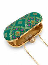 Light green oval clutch bag by THE TAN CLAN with a sleek, smooth surface and compact design for stylish occasions.