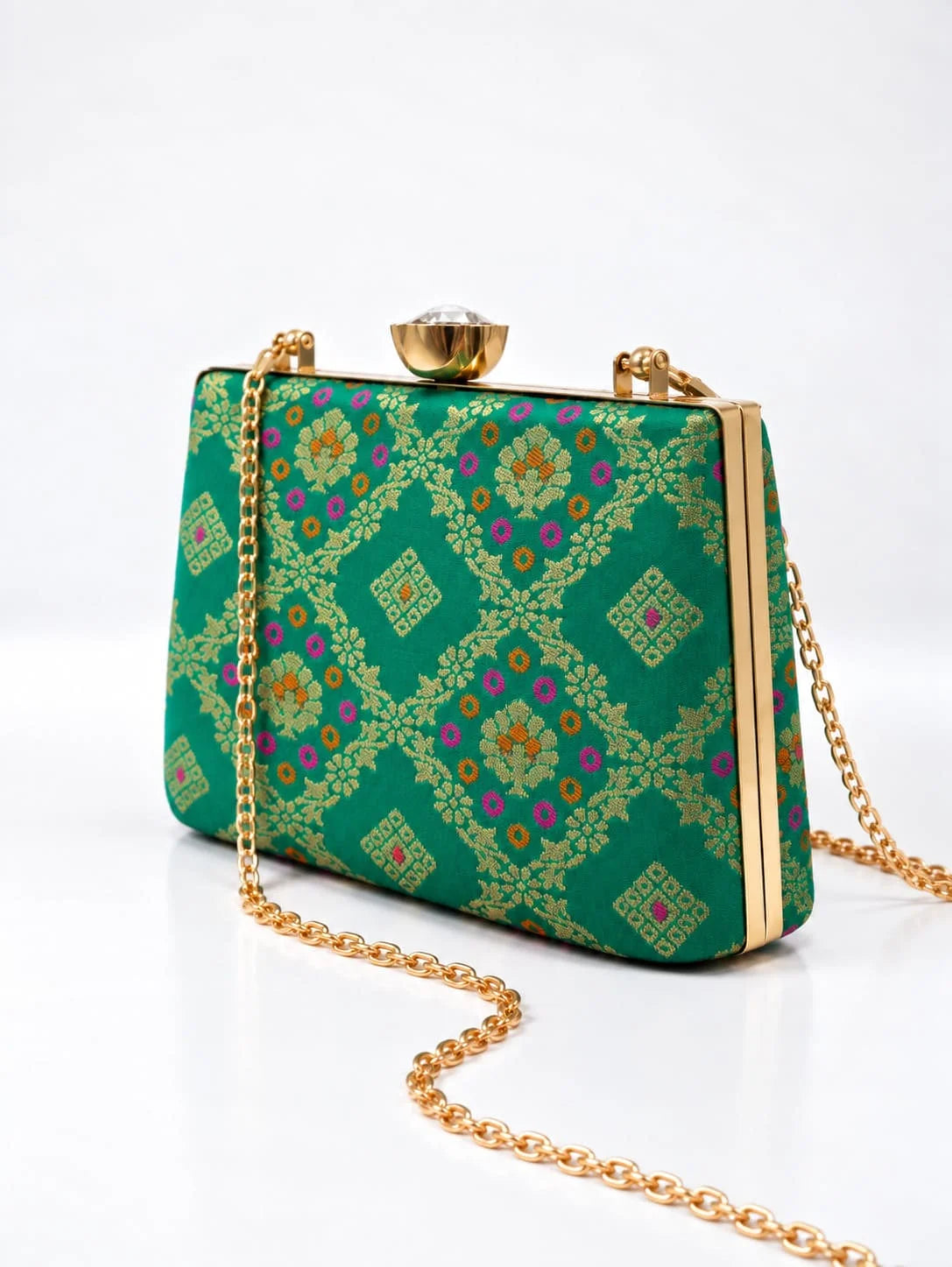 Light green casket clutch purse by THE TAN CLAN featuring a sleek, elegant design with a metallic clasp and textured finish.