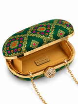 Dark green oval clutch bag by THE TAN CLAN, featuring a sleek design and compact size for stylish evening carry.