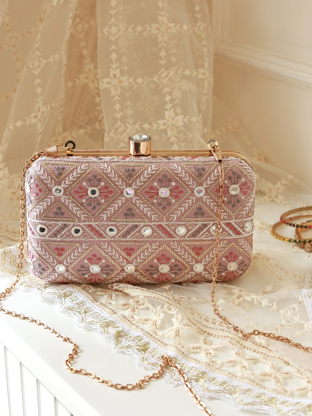 Pink box clutch bag by The Tan Clan featuring a sleek, modern design with a smooth finish and compact shape.