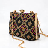 Black Mahi casket clutch bag by THE TAN CLAN with sleek design and compact size, perfect for evening or formal occasions.