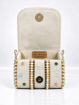 White hand-embroidered mini flap bag from THE TAN CLAN featuring intricate embroidery and a compact design.