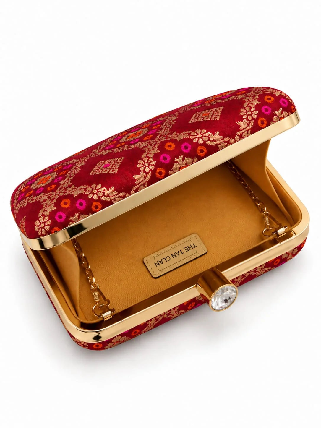 Red box clutch by THE TAN CLAN featuring a sleek design with a polished finish and compact size for elegant evening use.