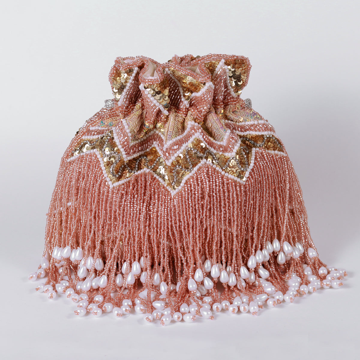 Asmi potli bag with tassels and handle by The Tan Clan, featuring intricate embroidery and traditional design.