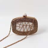 Alia Mother of Pearl Clutch by The Tan Clan featuring a shimmering pearl exterior and elegant fold-over design.