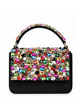 Black flap over bag from The Tan Clan, stylish flap bag with a sleek design, featuring a fold-over flap and top handle.