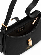 Close-up of THE TAN CLAN Dune black textured leather baguette shoulder bag interior with adjustable strap detail.