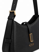 Black textured leather Dune shoulder bag by THE TAN CLAN with gold hardware and adjustable strap.