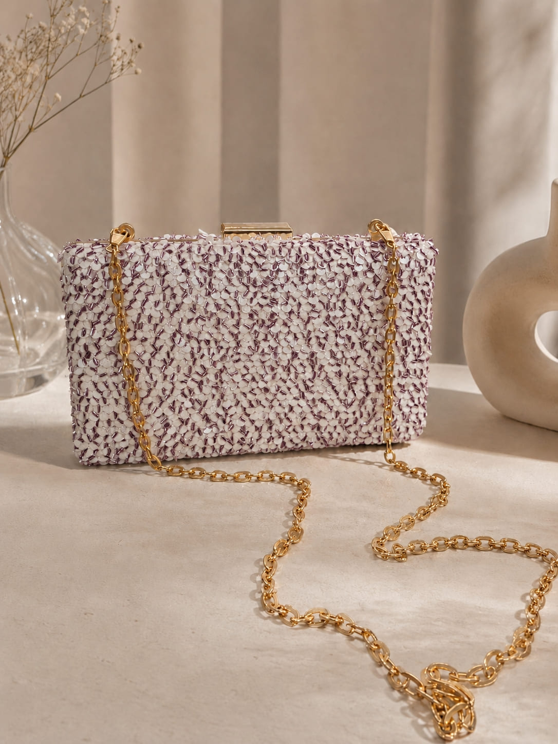 Pink sequined sleek clutch bag by The Tan Clan featuring shimmering embellishments and a compact, elegant design.