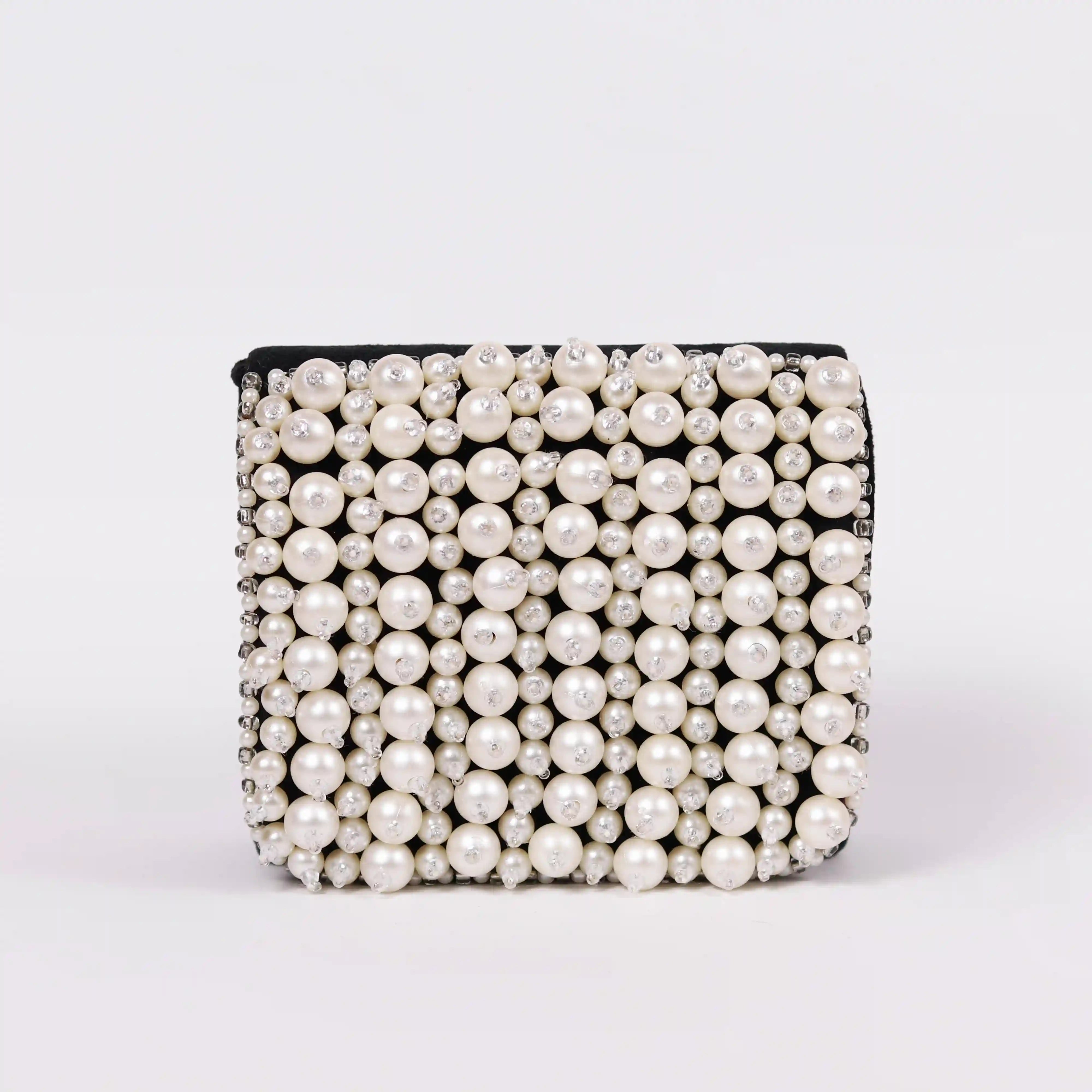 Black Jade Mini Bag by The Tan Clan with embroidered handle, featuring a compact design and stylish embroidered detail.