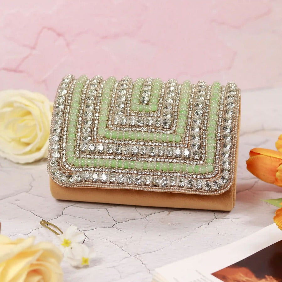 Green Nysa clutch bag with embellished flap over design by The Tan Clan, featuring elegant details and a sleek style.