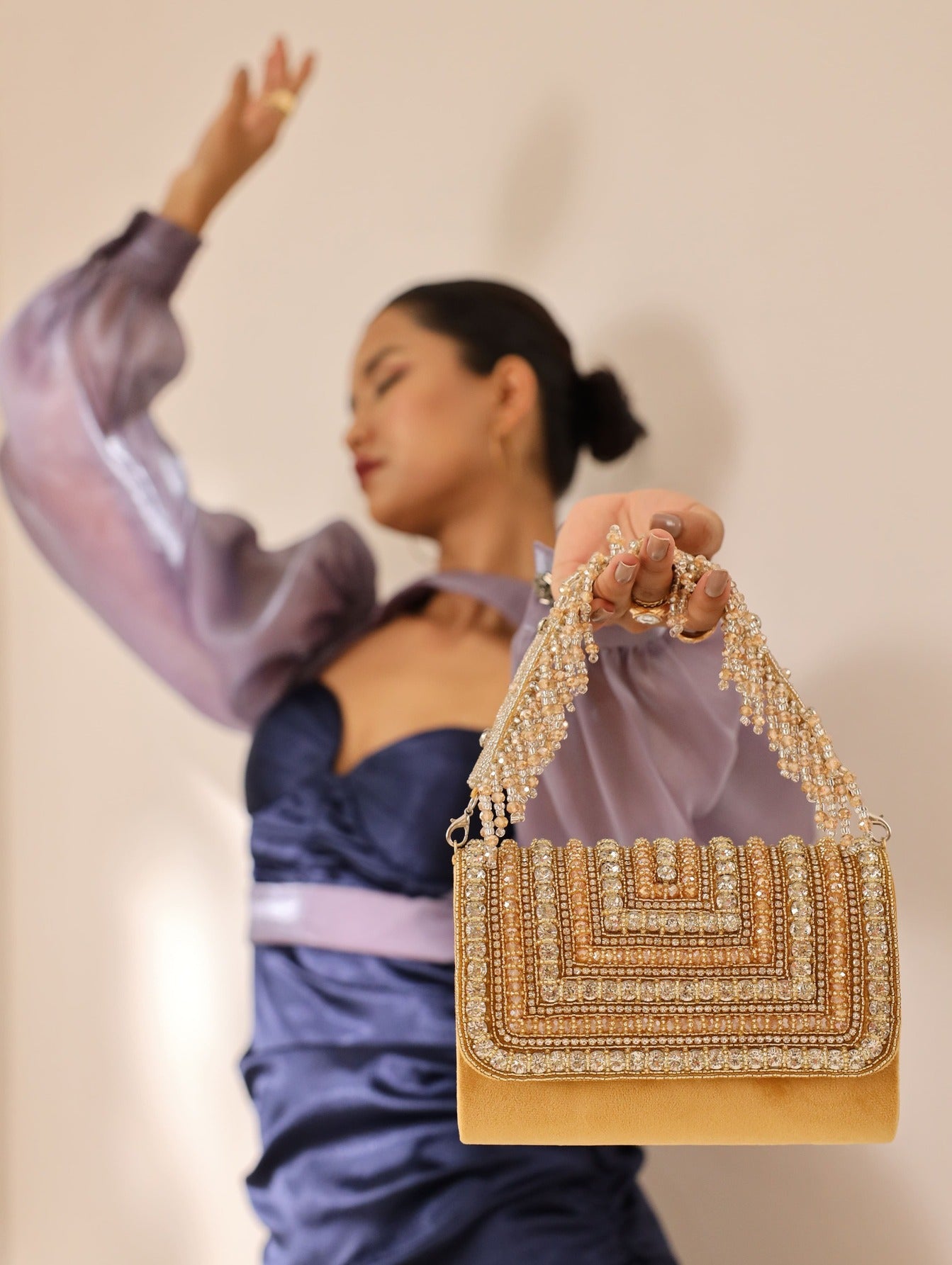 Nysa gold embellished flap-over clutch bag by The Tan Clan, featuring shiny gold accents and elegant design.