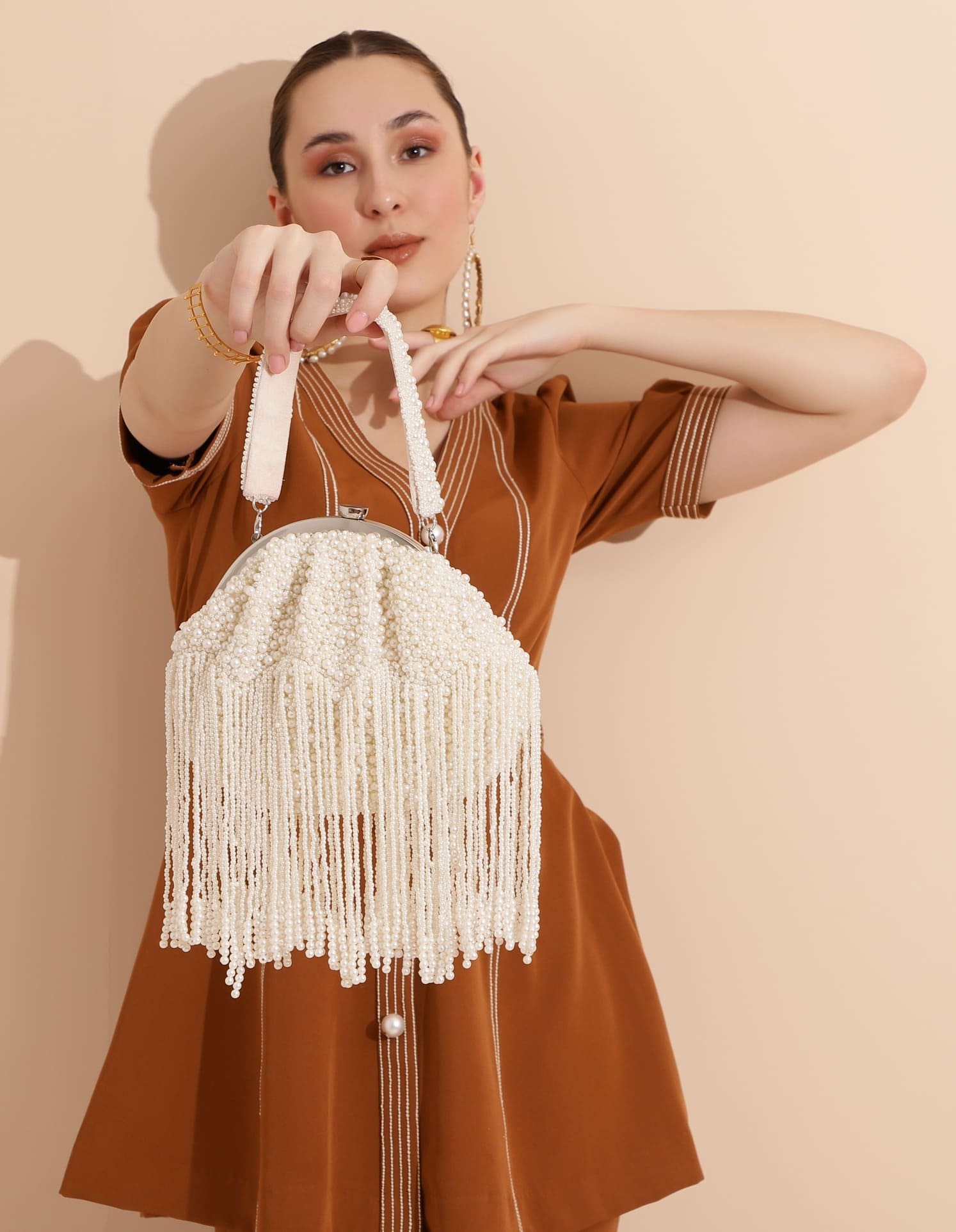 Pearl Batua bag with tassels from The Tan Clan featuring intricate pearl embellishments and hanging tassel details.