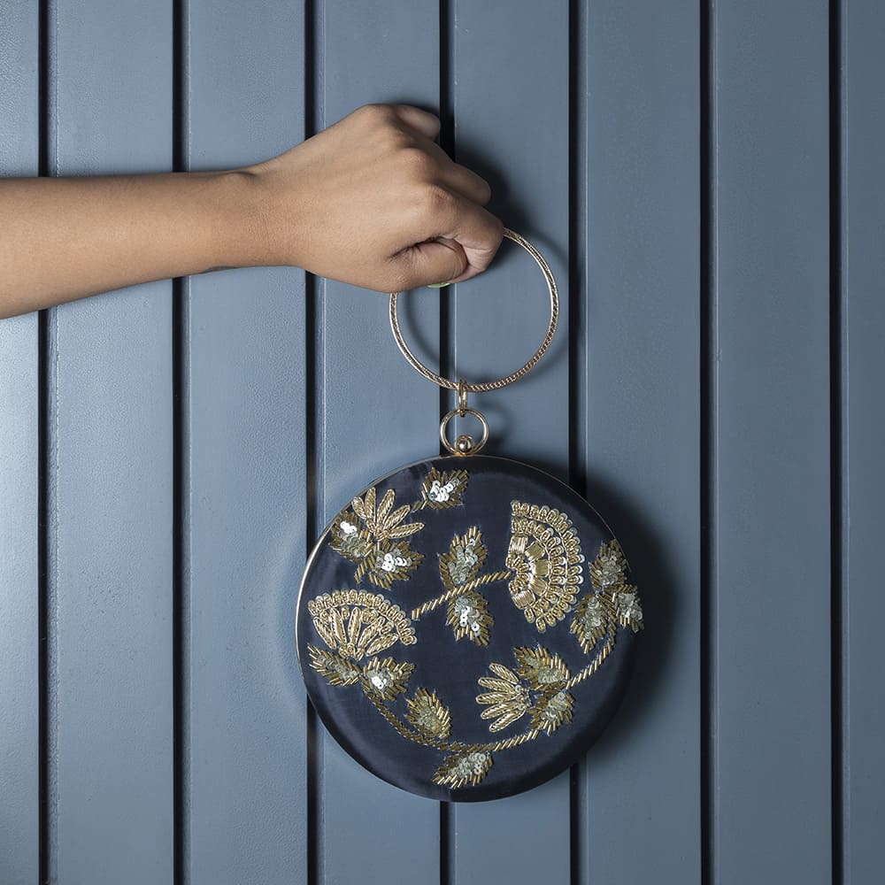 Black Rashida hand-embroidered clutch bag by The Tan Clan with intricate embroidery and elegant design.
