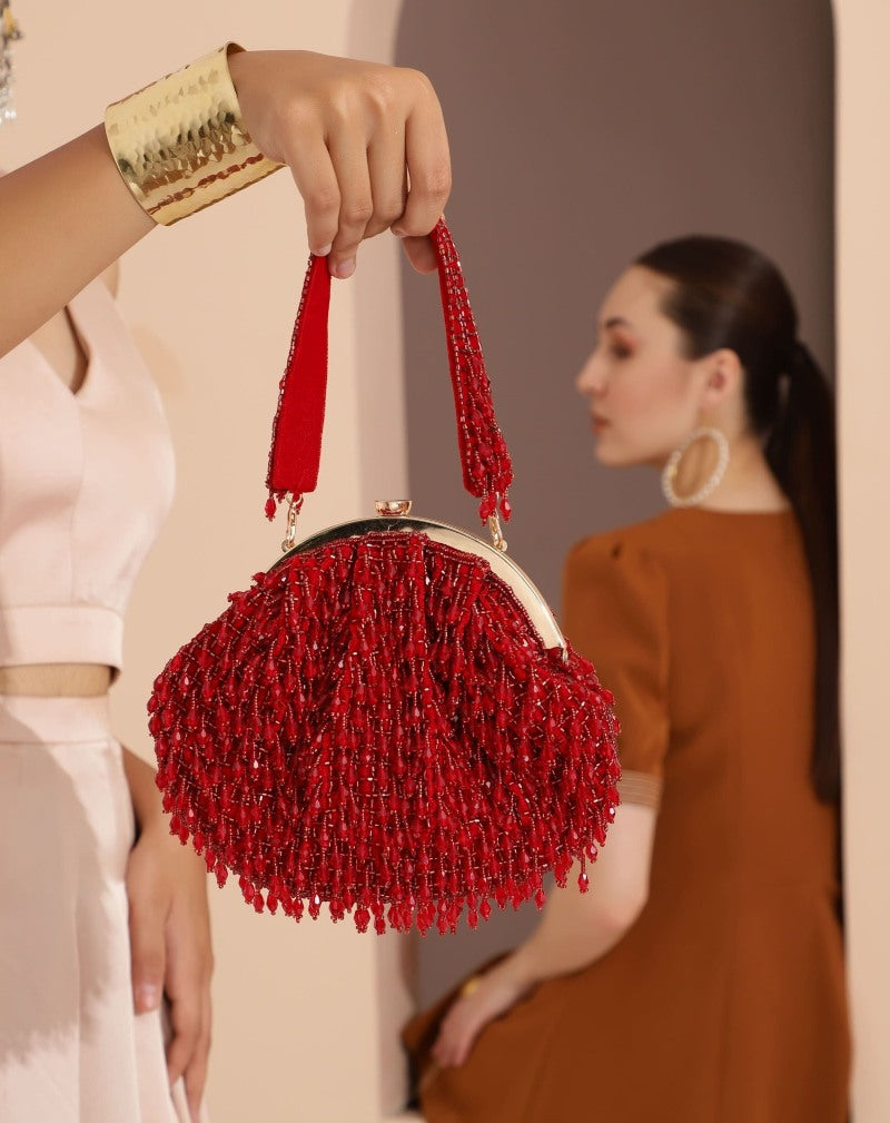 Red Rosa Batua bag with detachable handle by The Tan Clan, showing the stylish leather design and versatile carrying options.