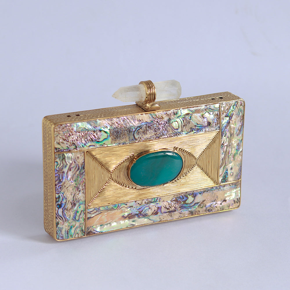 Golden embellished brass clutch bag featuring intricate details, designed by The Tan Clan for elegant occasions.