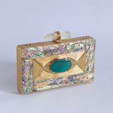Golden embellished brass clutch bag featuring intricate details, designed by The Tan Clan for elegant occasions.