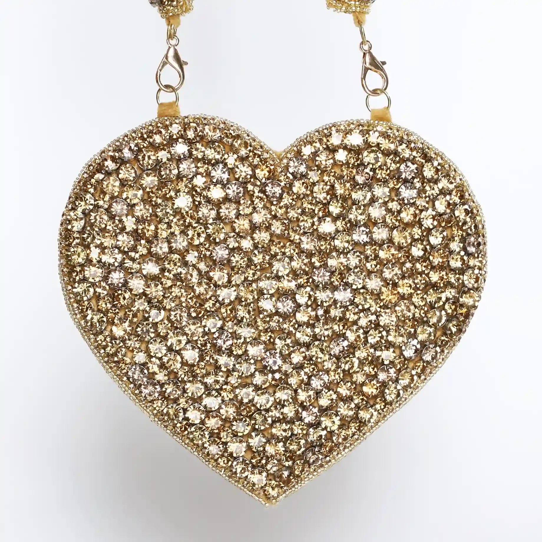 Scarlett Mini Heart Bag by The Tan Clan in gold with a sleek heart-shaped design and compact size for stylish carrying.