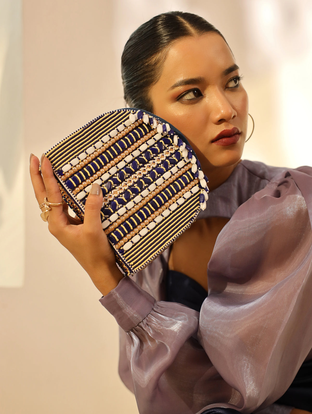 Blue flap-over bag with handle from The Tan Clan, featuring a stylish and spacious design for everyday use.