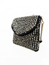 Black envelope bag from THE TAN CLAN featuring a sleek, minimalist design suitable for stylish everyday use.