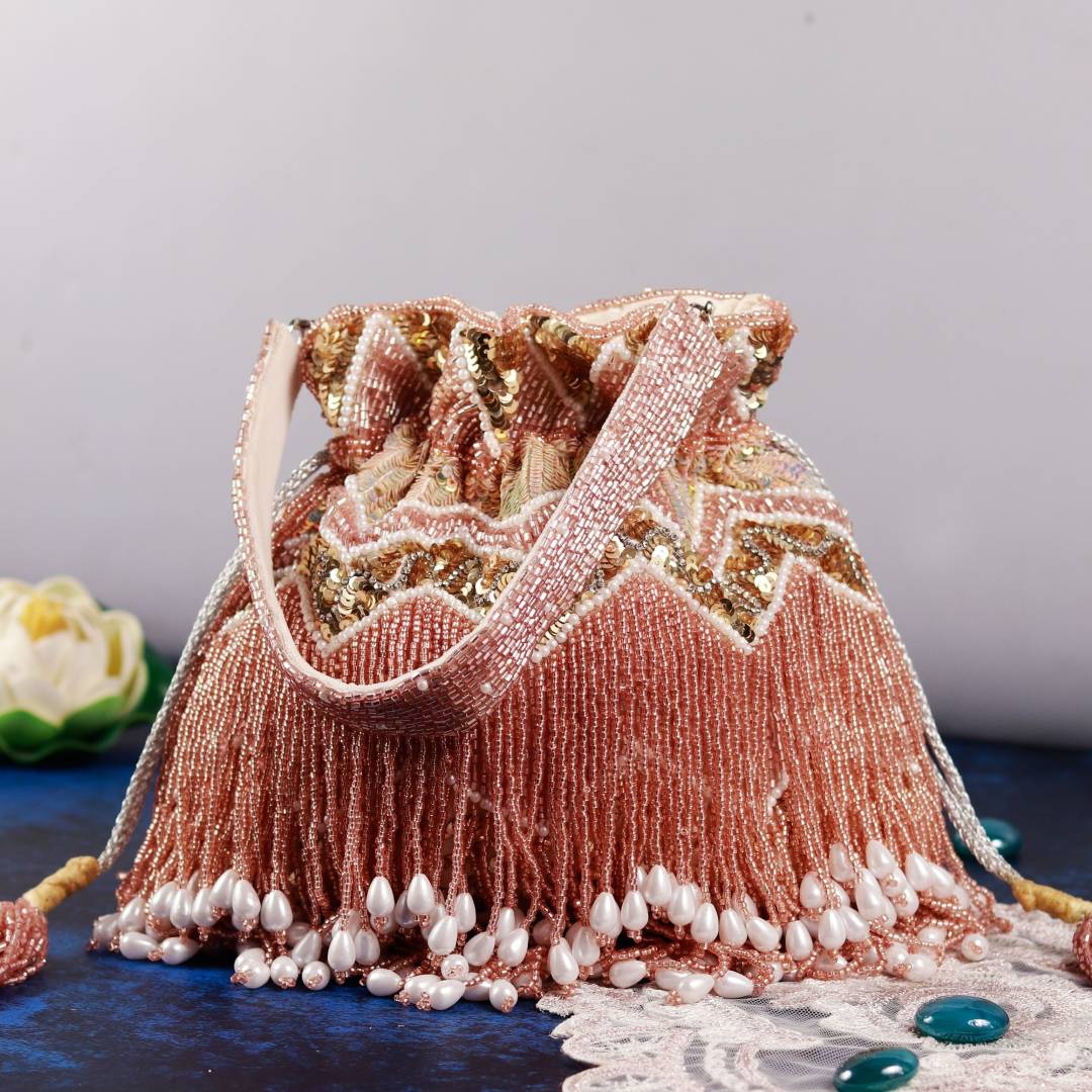 Asmi potli bag with tassels and handle by The Tan Clan, featuring decorative embroidery and traditional design.