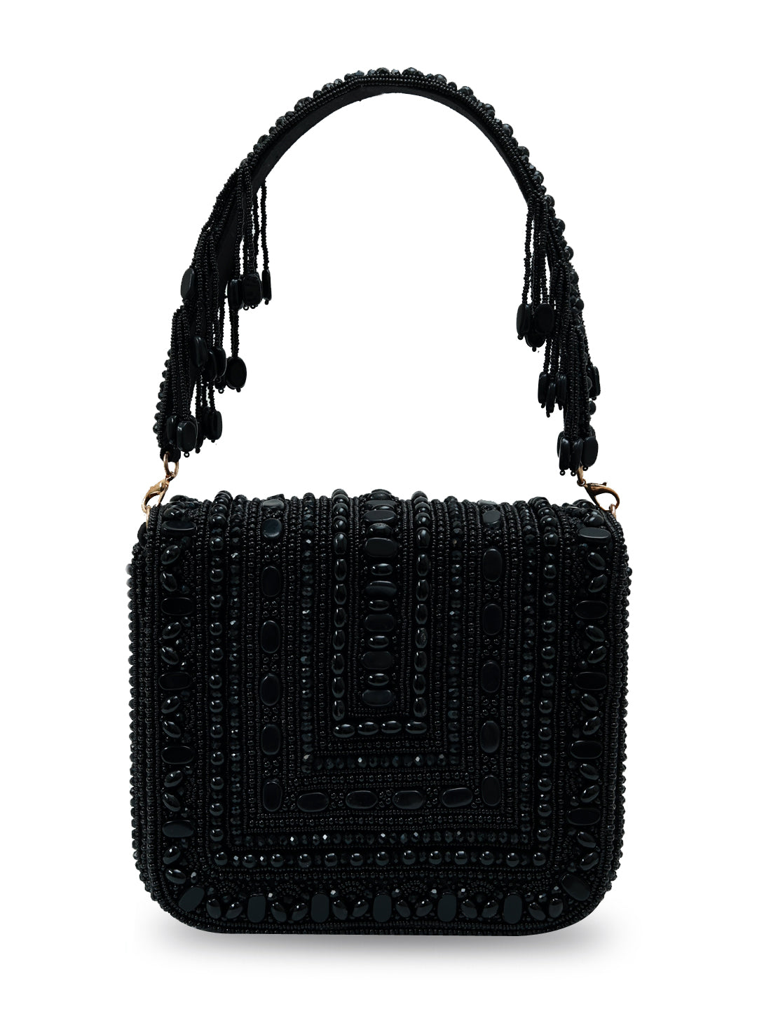 Black flap-over bag from The Tan Clan's Megan collection, featuring a sleek design and structured silhouette.