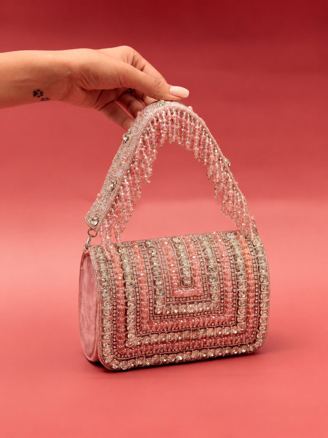 Pink Nysa embellished flap-over clutch bag with decorative details, stylish accessory from The Tan Clan.
