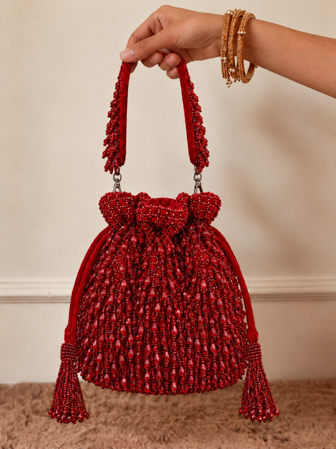 Red Rosa Potli Bag with handle by The Tan Clan, featuring traditional design and fabric details.