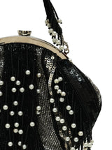 A black pearl Batua bag from The Tan Clan featuring traditional design and handcrafted details, displayed on a plain background.
