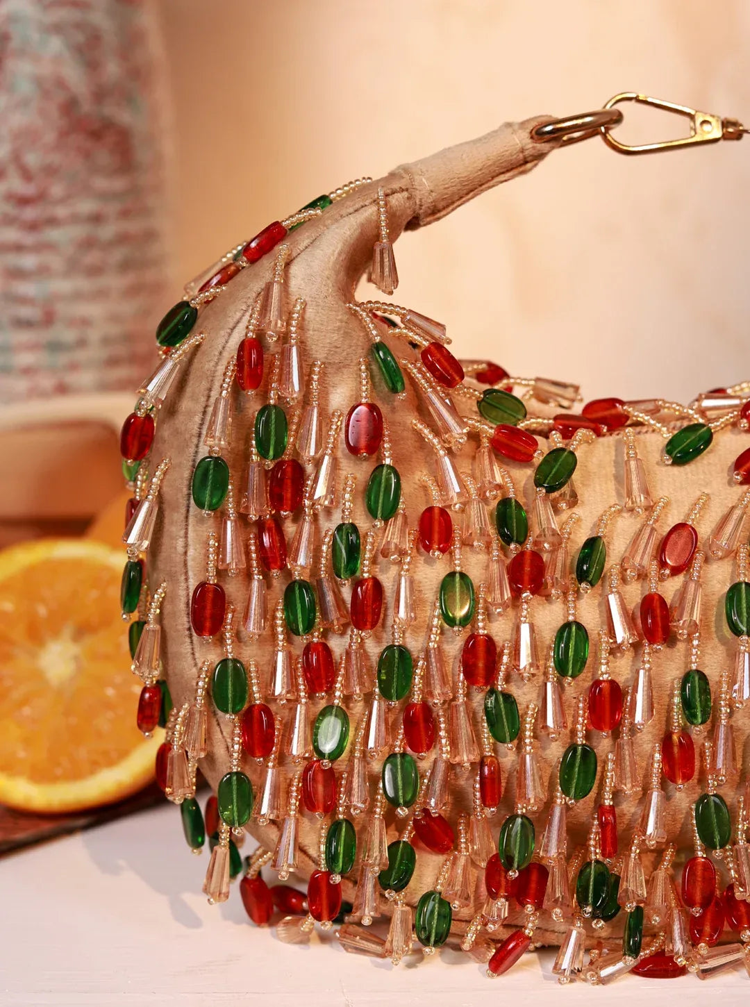Red and multicolor Bella half-moon Batua bag by The Tan Clan, featuring vibrant design and compact, stylish shape.