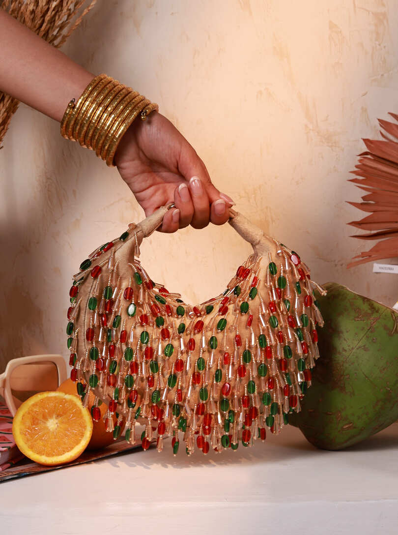 Red and multicolor Bella Half Moon Batua Bag by The Tan Clan with vibrant design and adjustable strap.