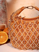 Diya Pearl Half Moon Batua Bag from The Tan Clan featuring pearl embellishments and a stylish half-moon shape.