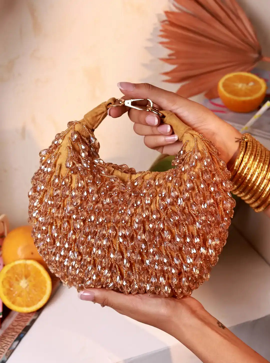 Jia Gold Half Moon Batua Bag by The Tan Clan featuring a sleek gold finish and elegant half-moon shape.