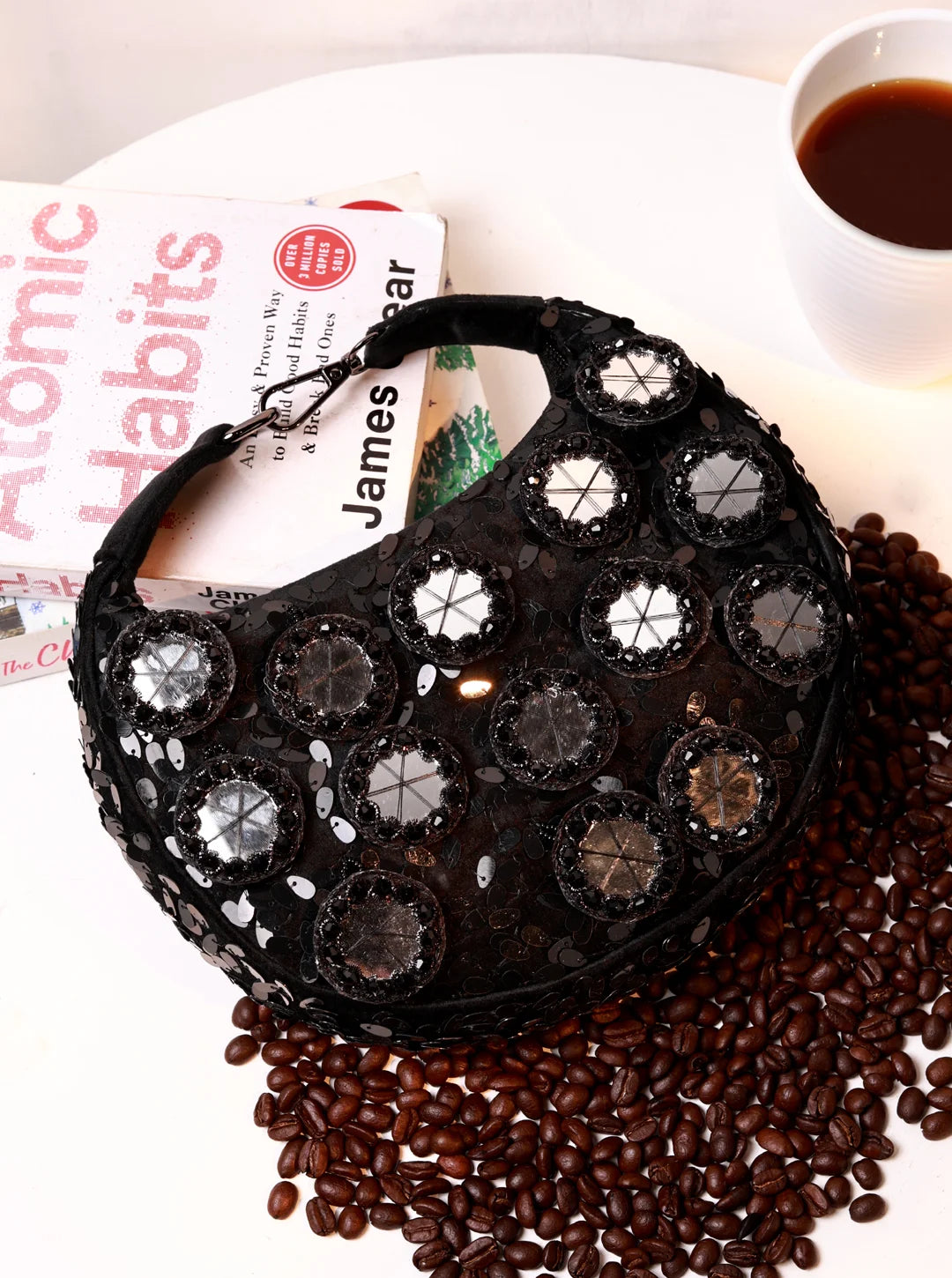 Black Kim Mirror Half Moon Bag by The Tan Clan, a stylish Batua bag with a sleek half moon shape and mirror accents.