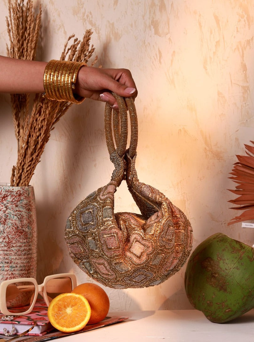 Luna Gold Half Moon Batua Bag by The Tan Clan featuring a shiny gold finish and elegant crescent shape.