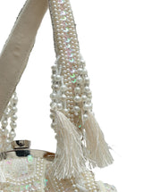 Nora Tasselled Half Moon Batua Bag by The Tan Clan featuring tassels and a curved half moon shape in tan color.