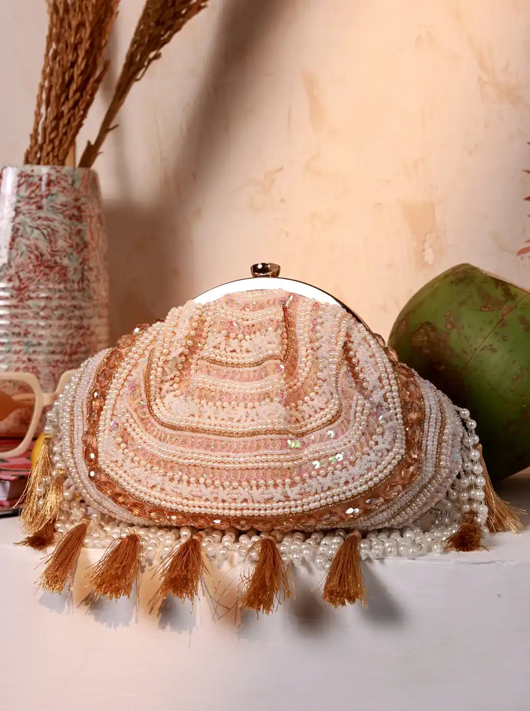 Nora Tasselled Half Moon Batua Bag by The Tan Clan featuring tassel details and a curved half-moon shape.