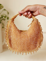 The Tan Clan Sera Golden Drop Pearls Batua Bag featuring a stylish, gold-pearl embellished design with traditional craftsmanship.