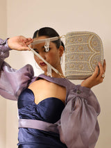 Grey Kavya flap-over bag with handle from The Tan Clan, showing front view with flap closure and top handle.