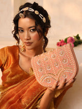 Pink flap-over bag with handle from The Tan Clan, featuring a stylish design and spacious interior.