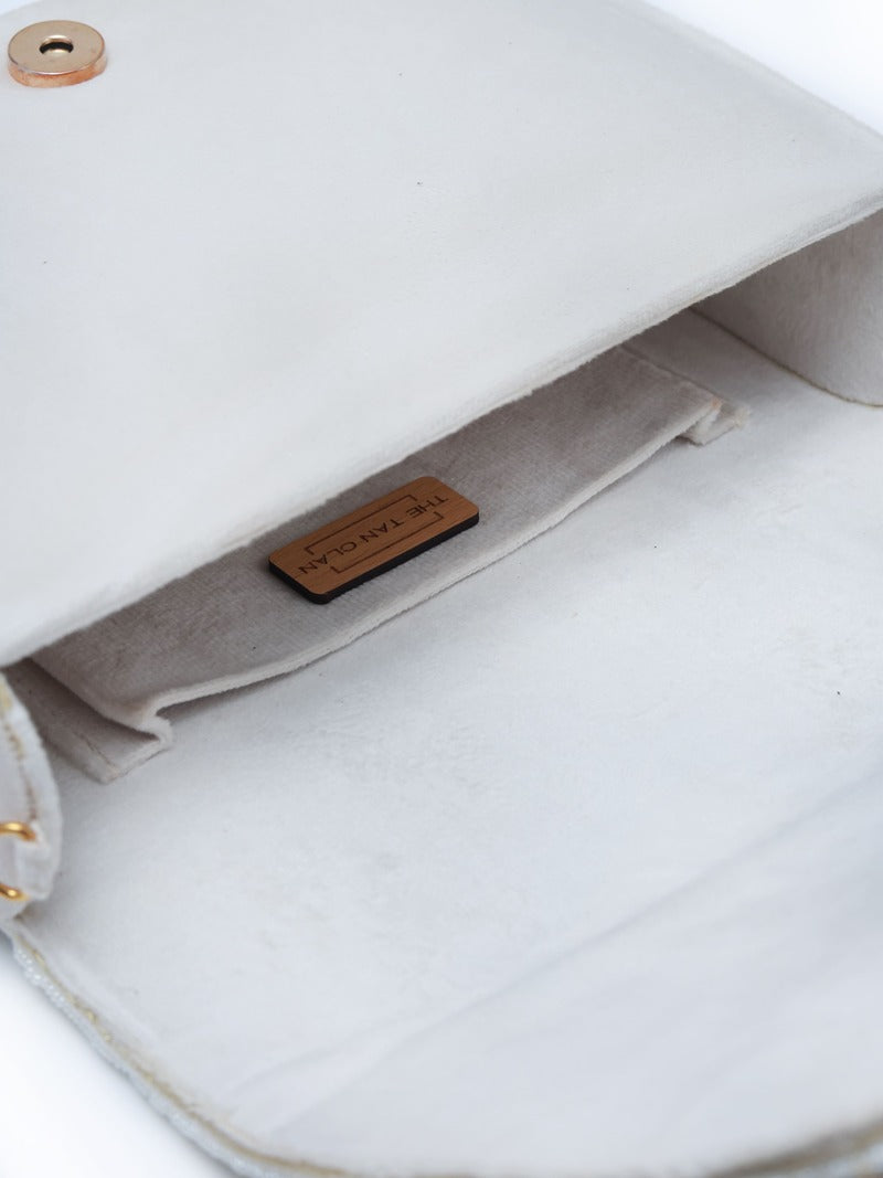 Kavya white flap-over bag with handle from The Tan Clan, featuring a stylish beige design and secure flap closure.
