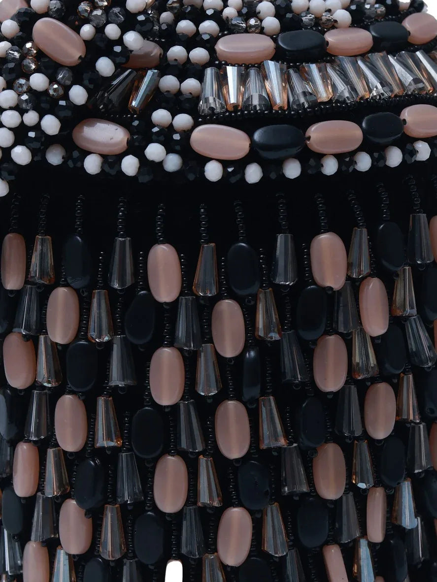 Black Bella round embellished bag with handle by The Tan Clan, featuring decorative details and a sturdy shoulder strap.