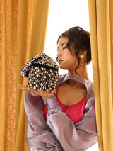 Black Bella round embellished bag with handle from The Tan Clan, featuring decorative accents and a stylish, compact design.