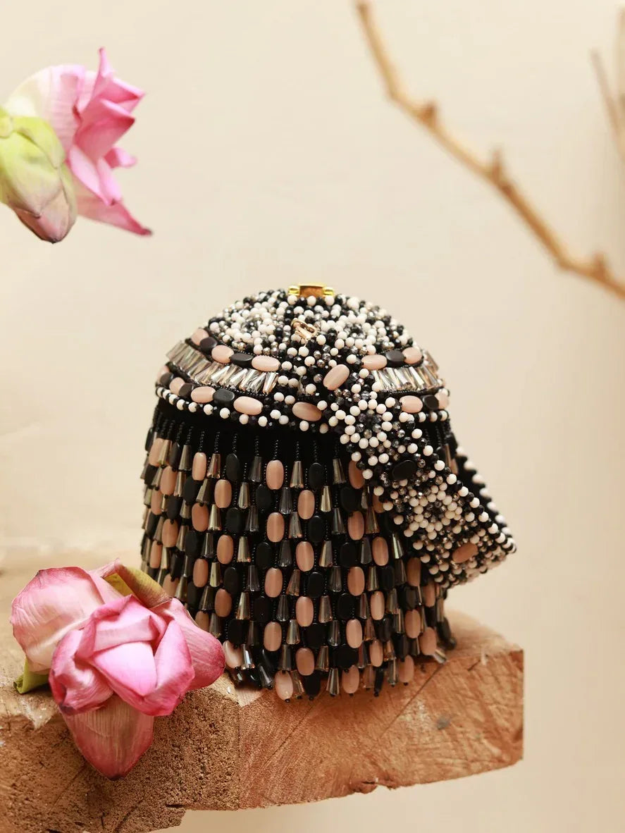 Black Bella round embellished bag with handle by The Tan Clan, featuring white decorative accents and a sleek, stylish design.